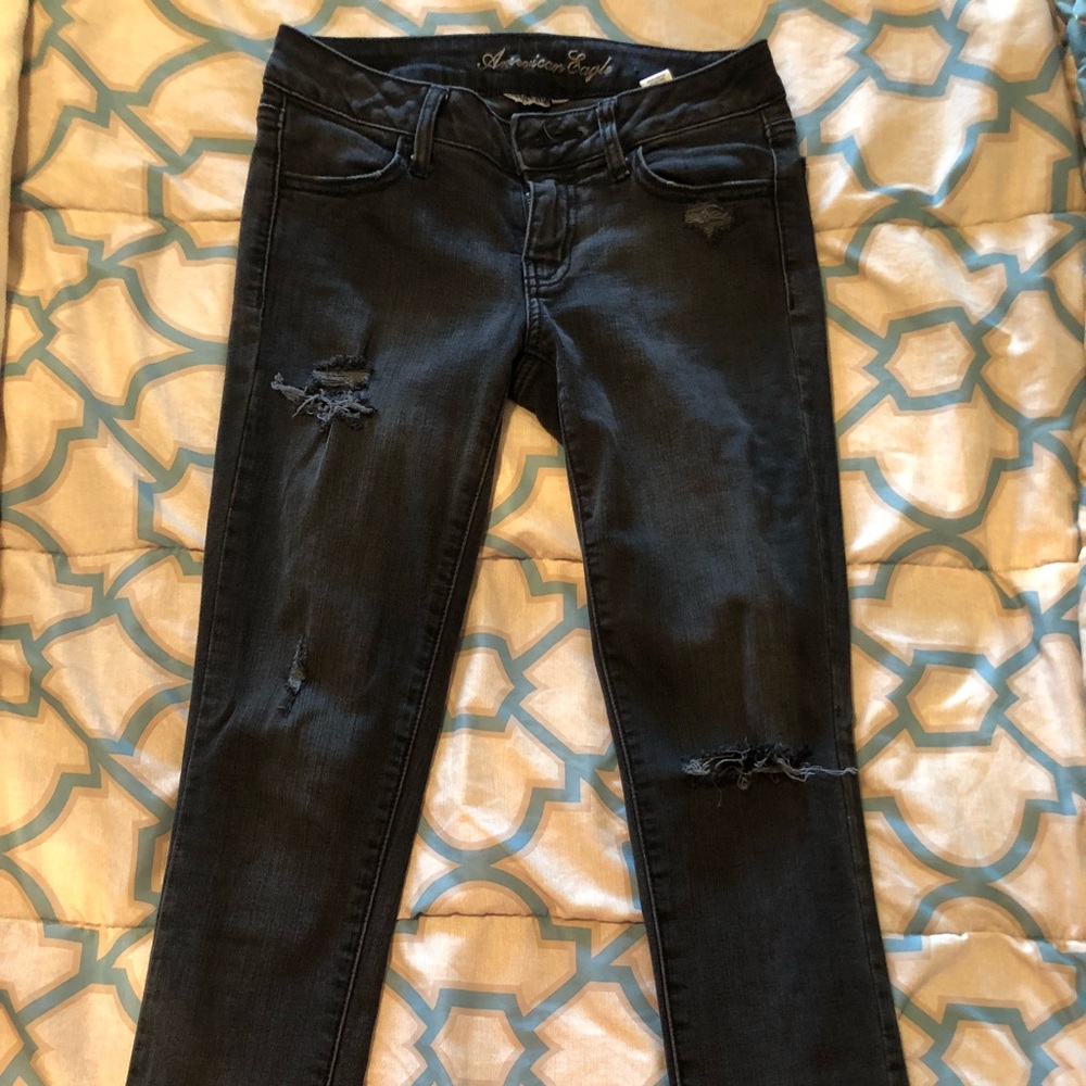 Distressed black skinny jeans